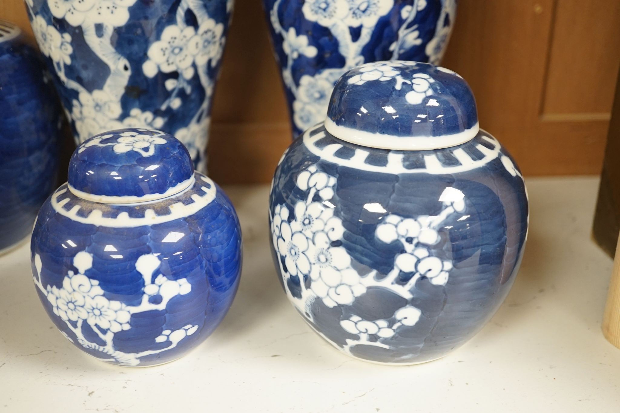 A pair of Chinese blue and white vases and eleven jars, six with covers., Vase and matching cover 28 cms high.